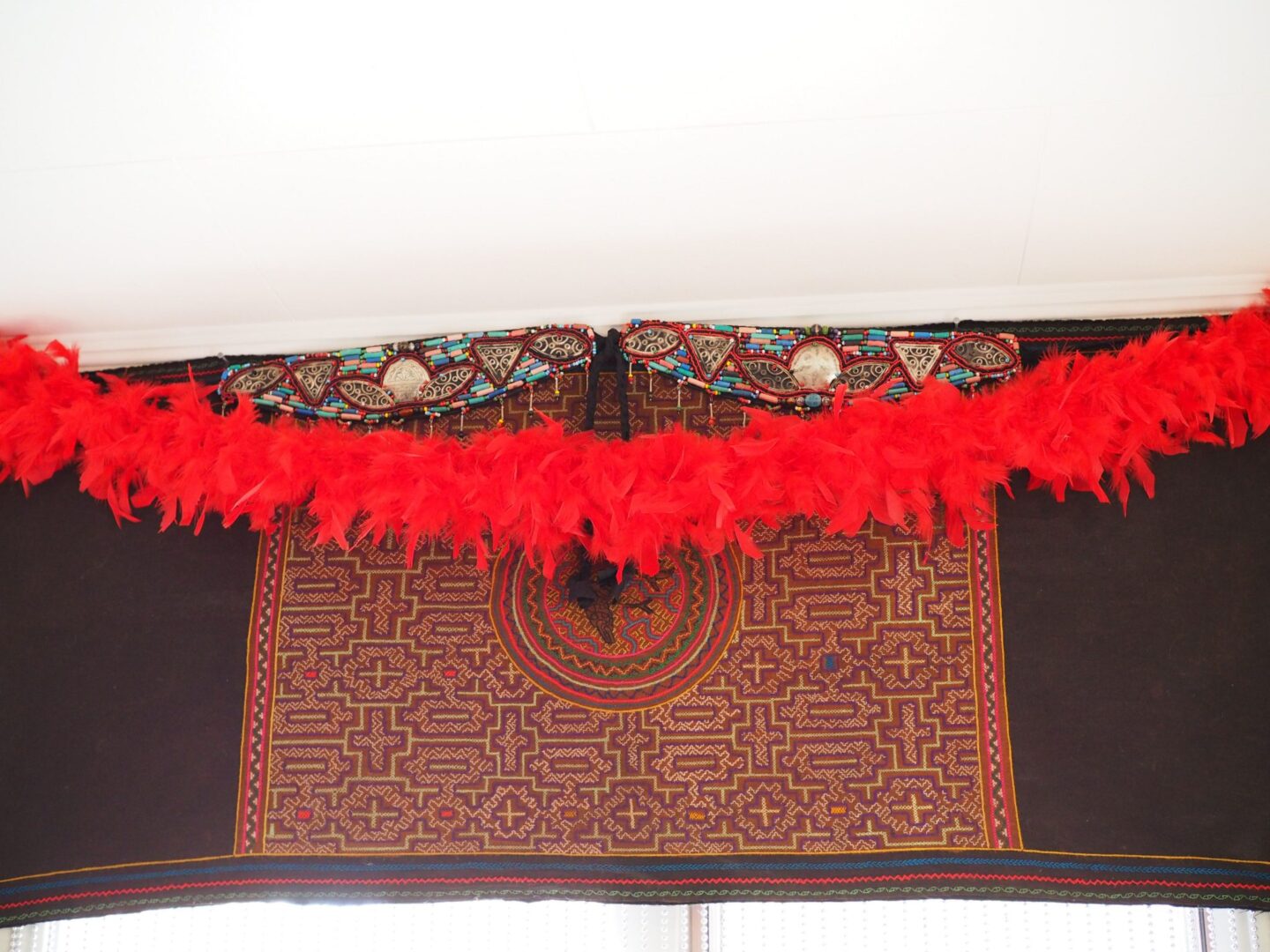A red feather boa hanging from the ceiling.