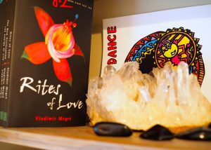 A shelf with two books and some crystals