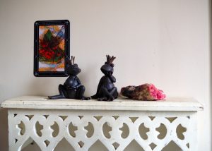 A couple of black statues sitting on top of a table.