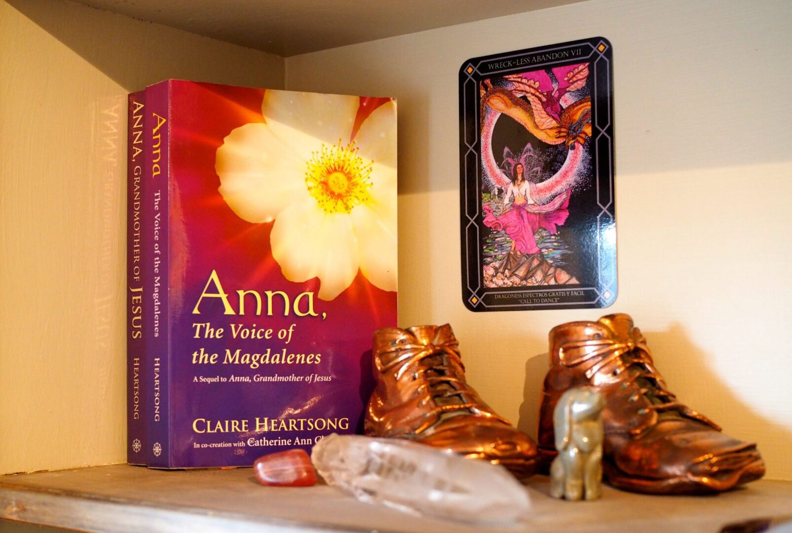 A book and some boots on top of a shelf.