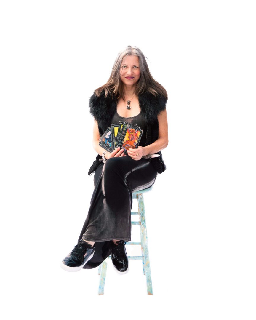 A woman sitting on top of a stool.